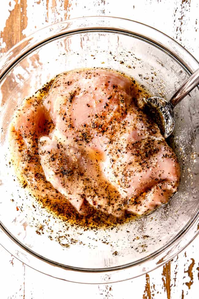 showing how to make lemon chicken pasta by marinating chicken in lemon marinade