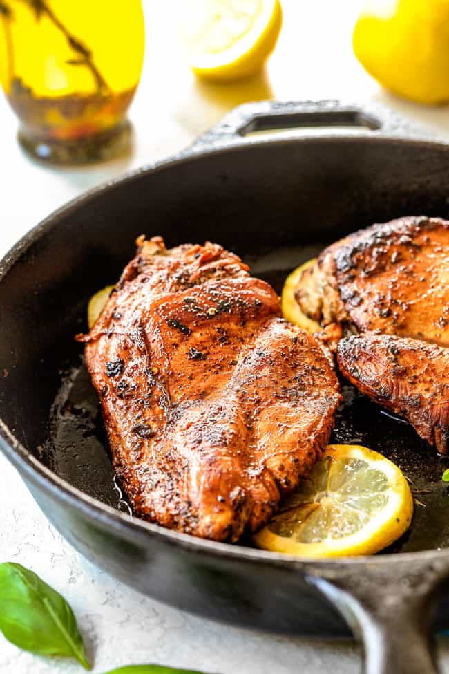showing how to make lemon chicken pasta by cooking chicken in a sksillet