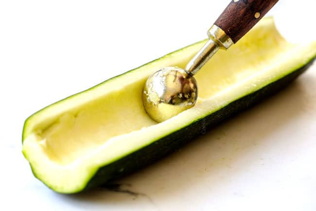 showing how to make zucchini boats by scooping out inside of zucchini with a measuring spoon