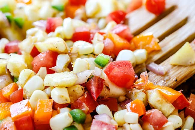 showing how to make stuffed zucchini boats recipe by cooking vegetables in a skillet