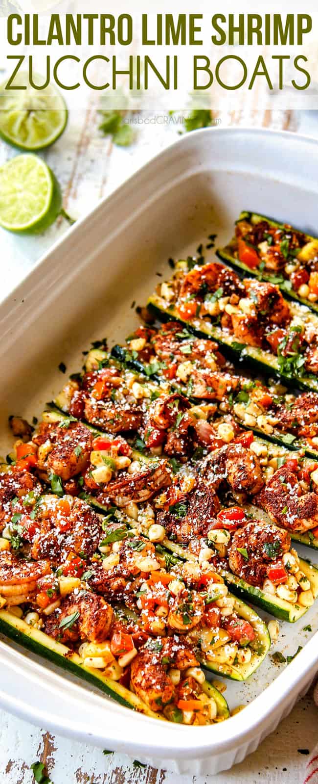side view of baked zucchini boat recipe in a white 9x13 baking dish