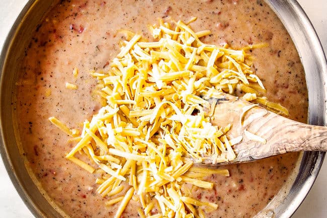 showing how to make easy chicken spaghetti recipe by adding cheese to spaghetti sauce