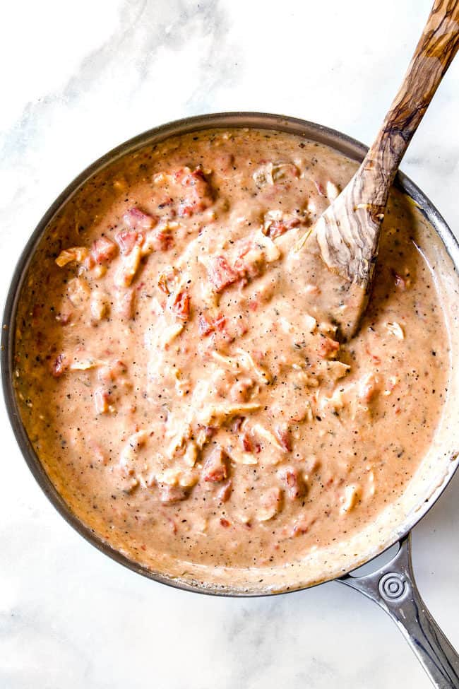 top view showing how to make chicken spaghetti sauce by combining chicken and Rotel tomatoes in creamy sauce