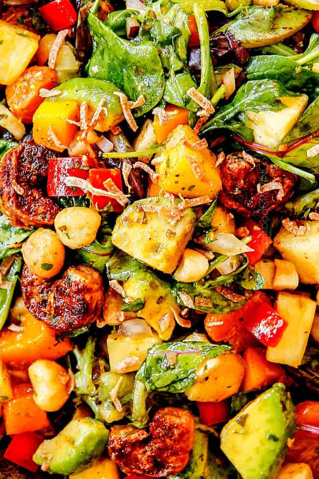 up lose view of shrimp avocado salad recipe with blackened shrimp, avocados, pineapple, mangos, kiwis, coconut, macadamia nuts