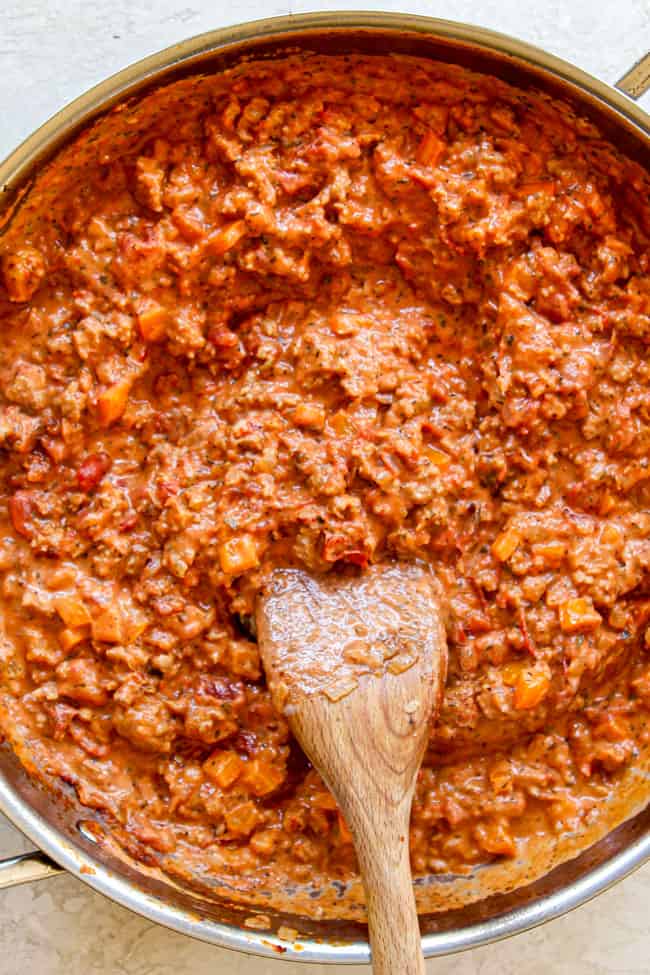 showing how to make rigatoni recipe by simmering tomato cream saaue