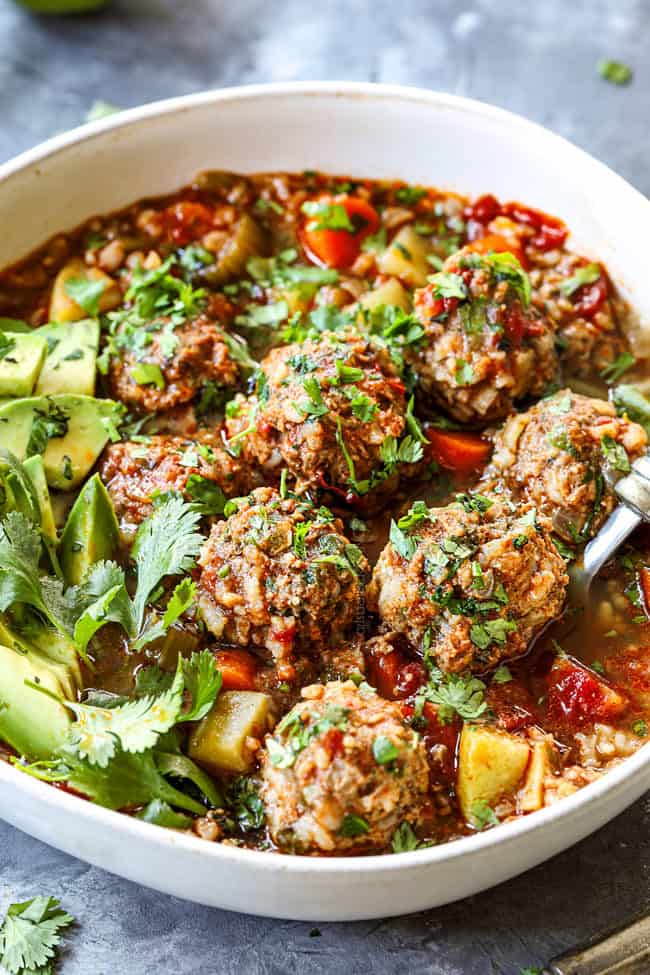 a spoon scooping up a meatball in authentic Albondigas Soup