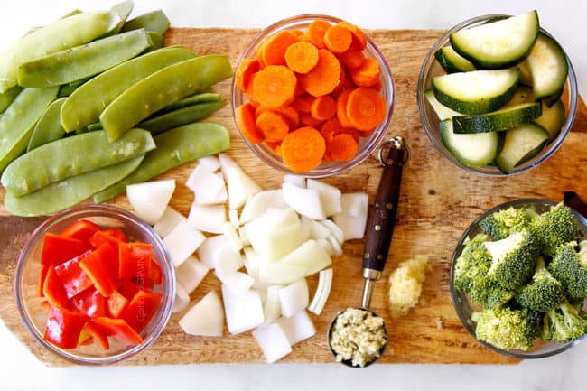 showing how to make stir fry by prepping stir fry vegetables on a cutting board