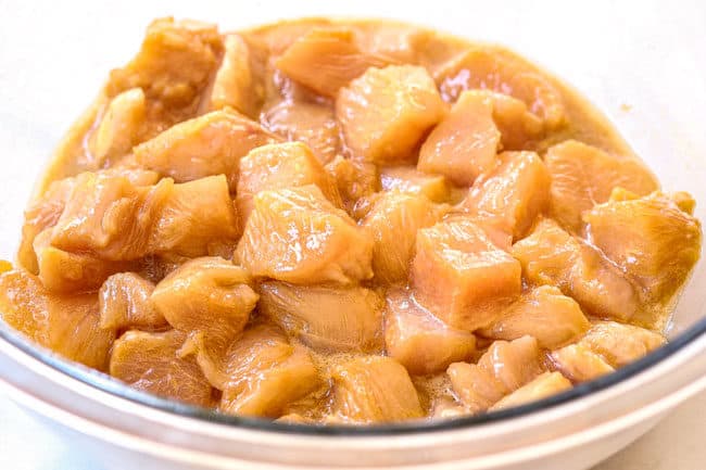 showing how to make healthy chicken stir fry by velvetting chicken in glass bowl