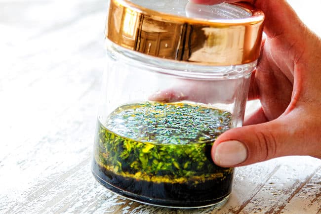 showing how to make green bean salad by shaking dressing in a mason jar