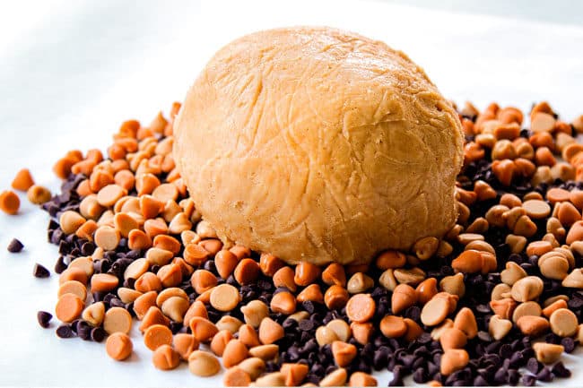 showing how to make peanut butter balls by spreading out coating chips in an even layer and adding cheese ball