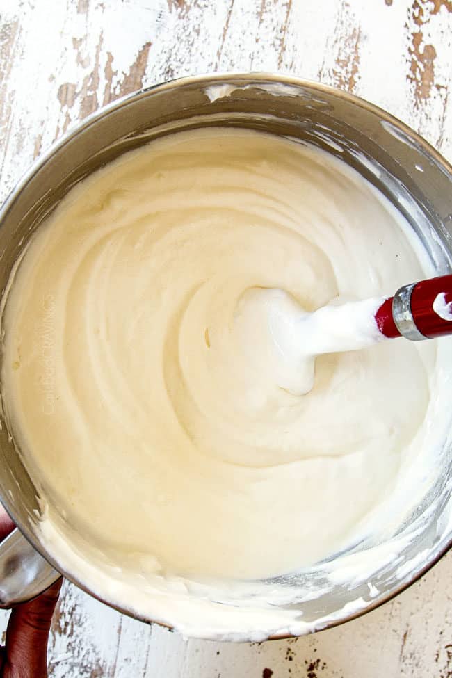 showing how to make easy pumpkin cheesecake bars by beating cheese, sugar, eggs, sour cream together