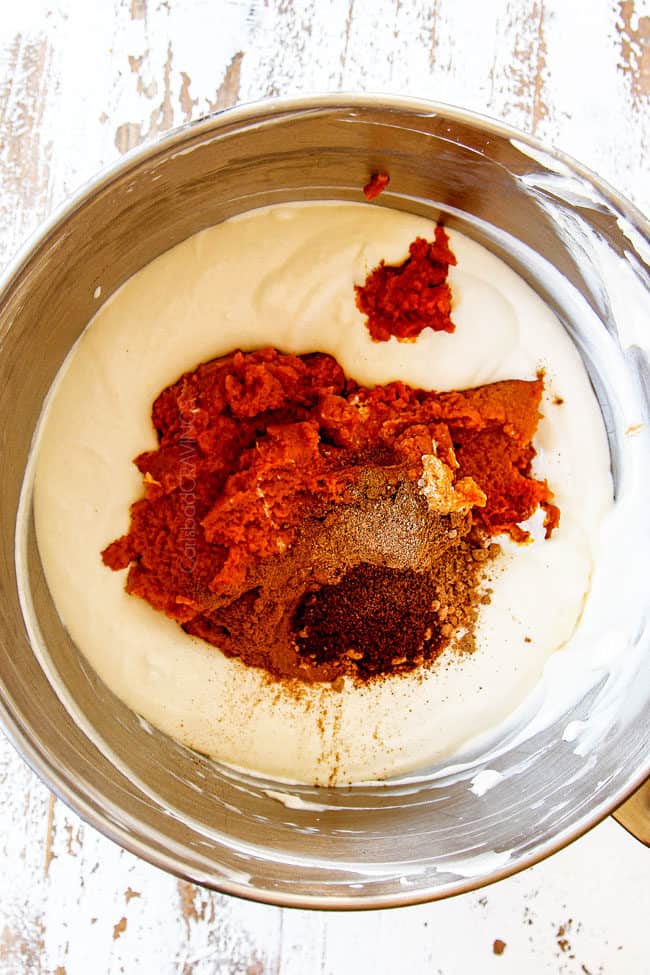 showing how to make pumpkin cheesecake bars by adding pure pumpkin, cinnamon, nutmeg, cloves and ginger to cheesecake