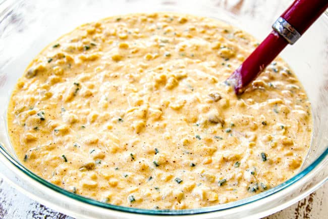 showing how to make corn casserole recipe by mixing wet and dry ingredients together until combined