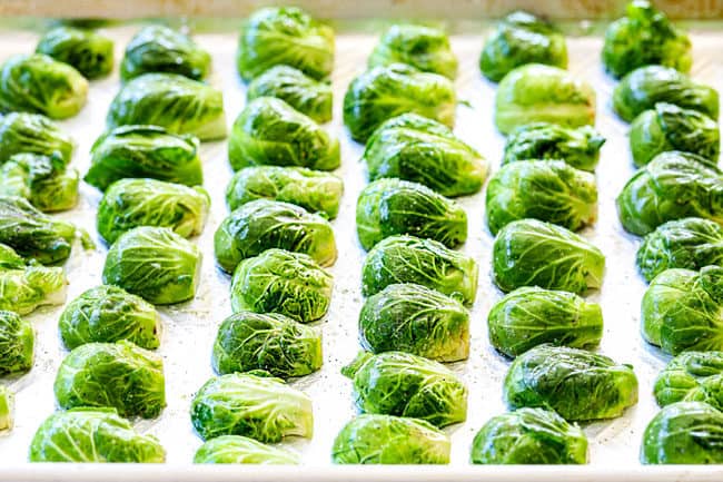 showing how to cook Brussels Sprouts recipe in oven by laying Brussels Sprouts flat on a baking sheet