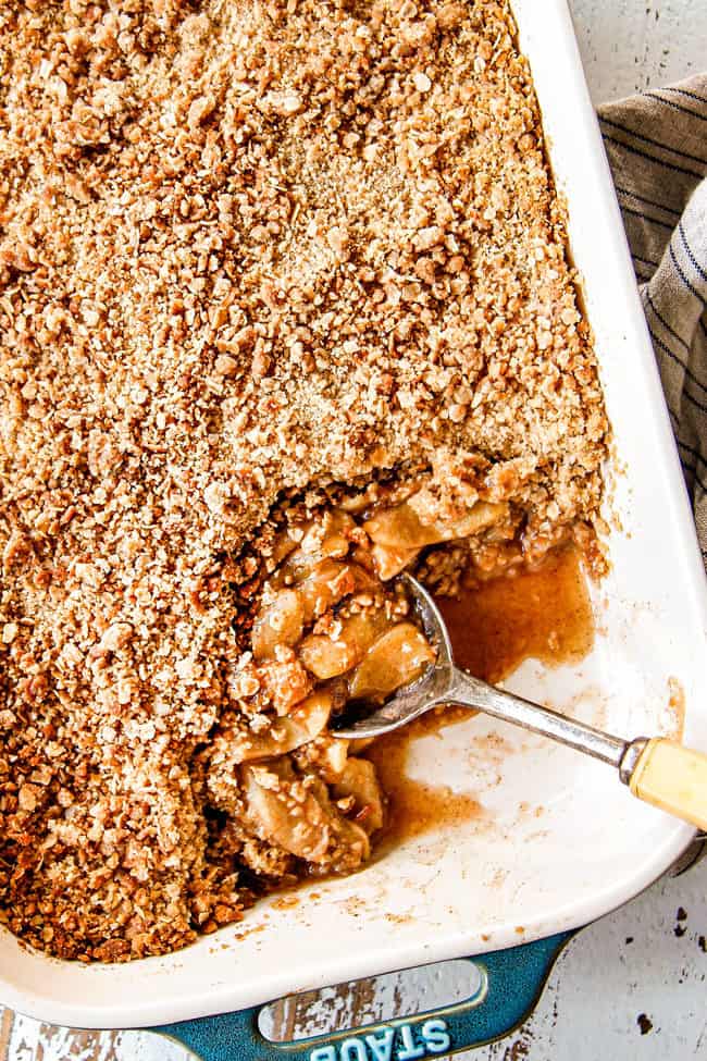 top view of a spoon digging into the best apple crisp recipe to serve