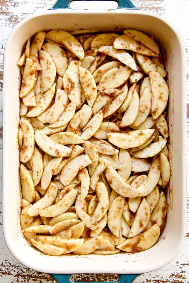 showing how to make easy apple crisp recipe by layering sliced apples in 9x13 pan
