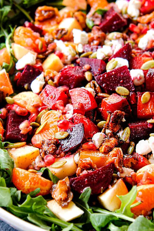 up close of roasted beet salad with roasted beets, oranges, walnuts, pomegranate and goat cheese