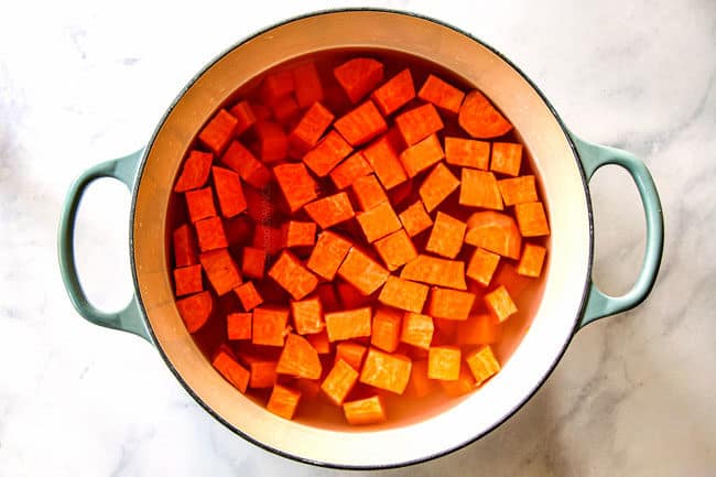 showing how to make mashed sweet potatoes by adding peeled, cubed sweet potatoes to a pot with water