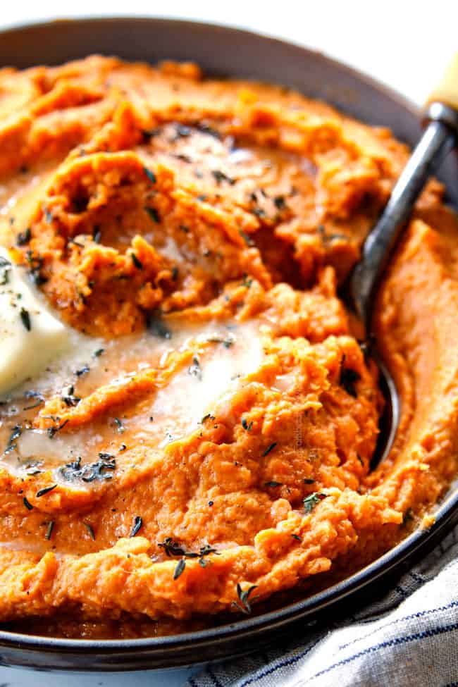 up close of a spoon serving mashed sweet potatoes