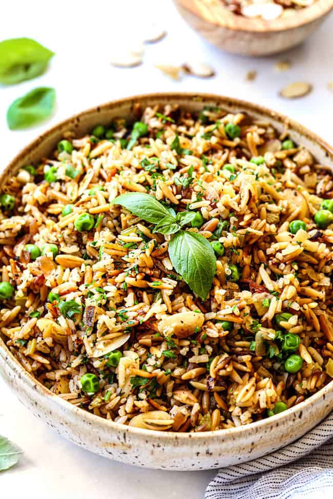 showing how to make rice pilaf recipe by transferring to serving bowl