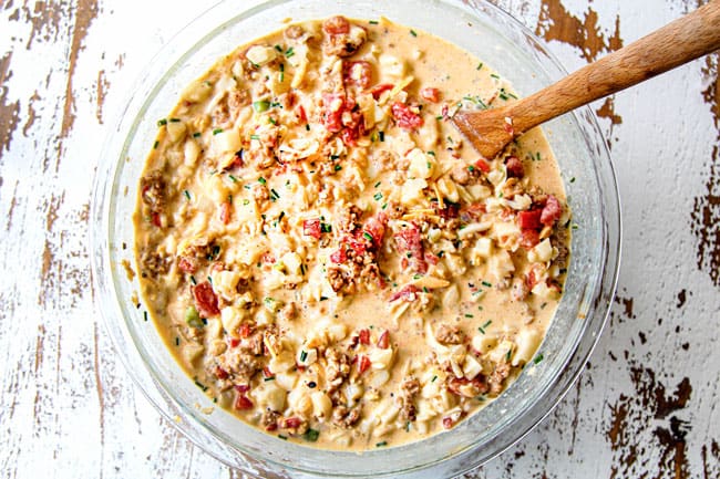 showing how to make breakfast casserole by mixing sausage, hash browns, cheese with eggs and heavy cream