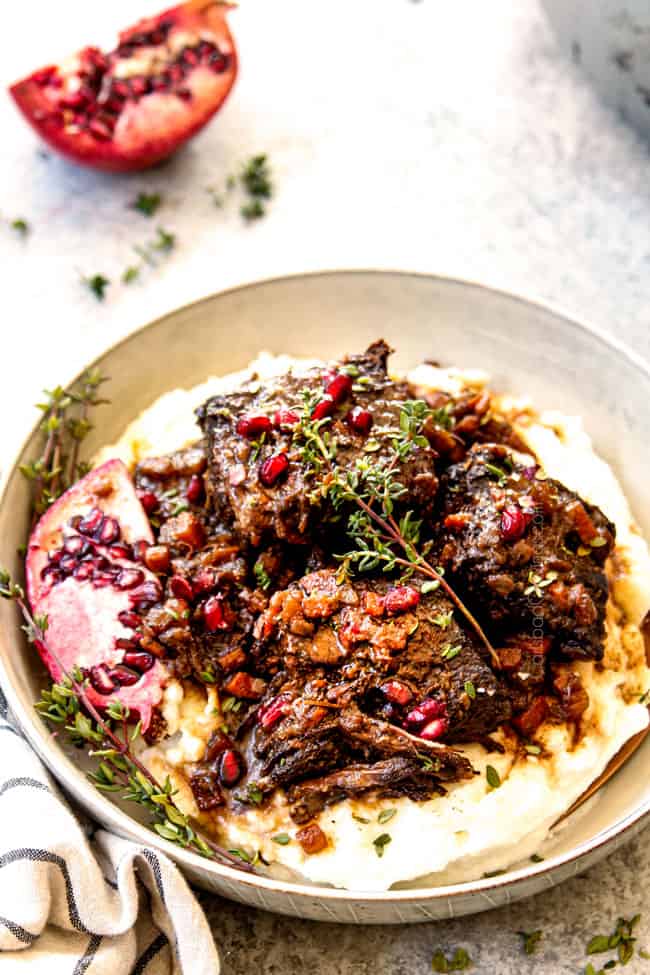 showing how to serve braised short ribs recipe by spooning sauce over ribs