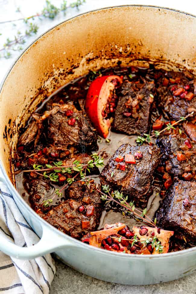 showing how to cook short ribs recipe in a Dutch oven with carrots, onions and celery