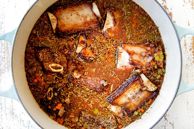 showing how to make short ribs by adding beef broth, pomegranate juice and seasonings
