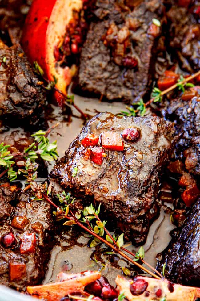 up close of beef short ribs cooking in a Dutch oven