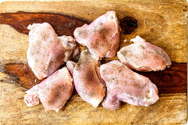 showing how to make chicken noodle soup by seasoning chicken with salt and pepper