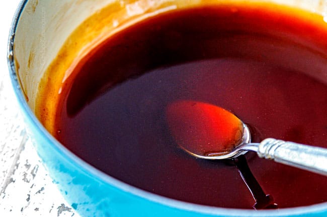 showing how to make egg rolls by making dipping sauce by adding sugar, ketchup, vinegar to saucepan to simmer