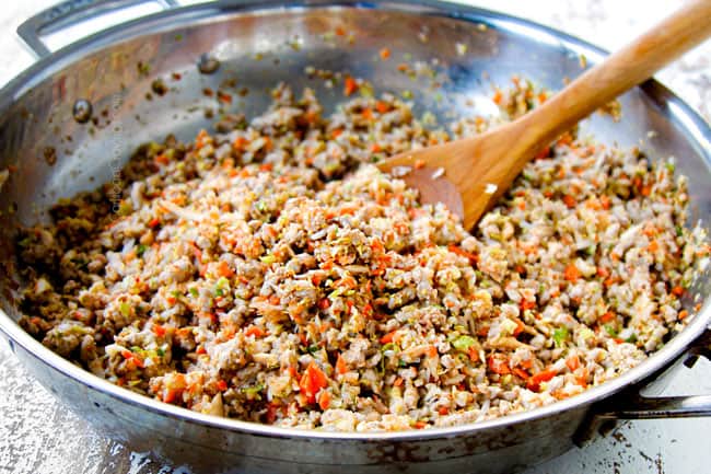 showing how to make easy egg rolls by adding chopped vegetables to pork