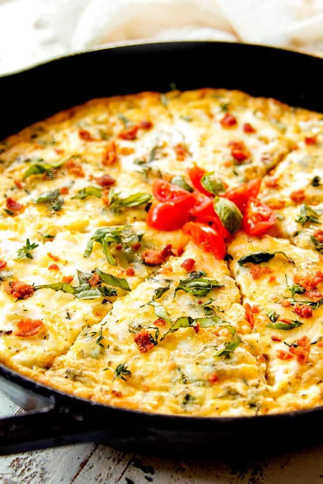 up close of a slice of easy egg frittata with bacon, broccoli, tomatoes and cheese