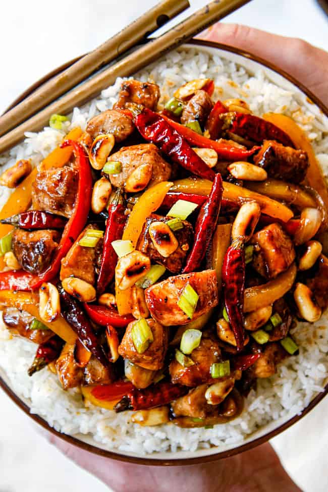 top view of showing how to serve Szechuan chicken in a bowl with chopsticks
