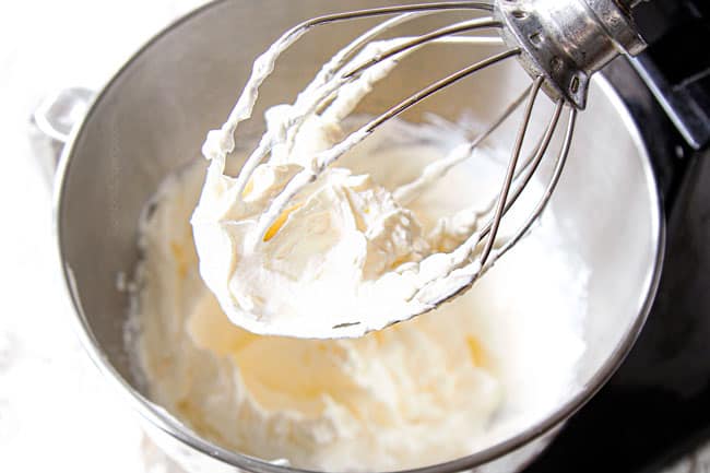 showing how to make tres leches cake by making whipped topping