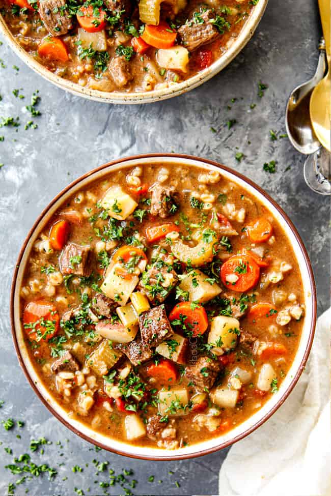 top view of beef barley soup with beef, carrots, celery onions and barley