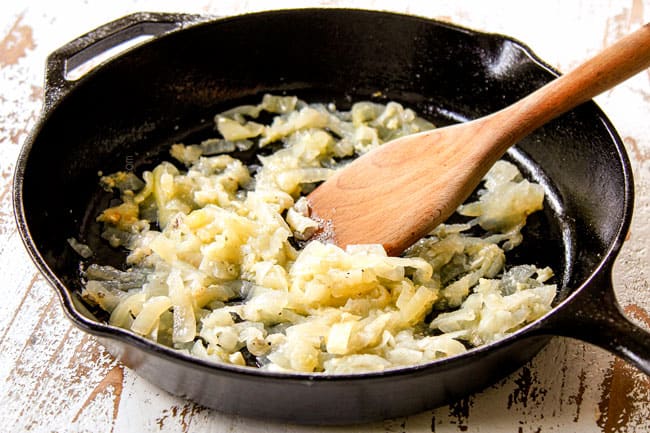 showing how to make chicken tinga by cooking onions in a skillet