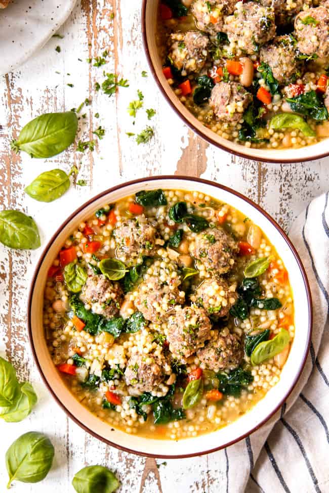 top view of showing how to serve Italian Meatball Soup recipe by garnishing with parsley and basil