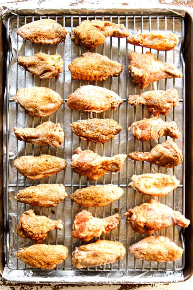 showing how to make Korean Chicken Wings by lining wings on a baking sheet to bake in the oven