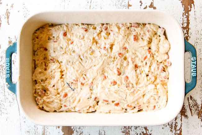 showing how to make green enchilada casserole by layering corn tortillas with chicken and green enchilada sauce