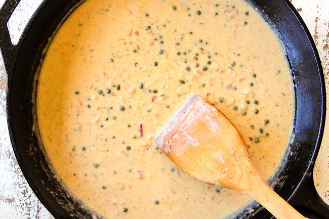 showing how to make chicken piccata recipe by simmering lemon, capers, garlic together