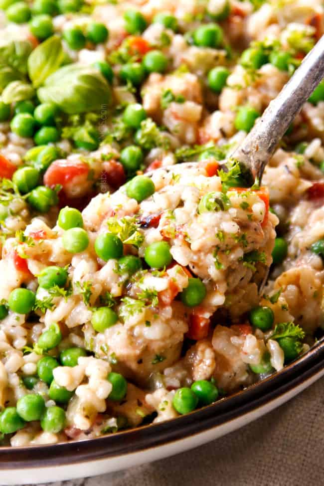 up close a serving spoon scooping creamy chicken and rice recipe showing how creamy it is