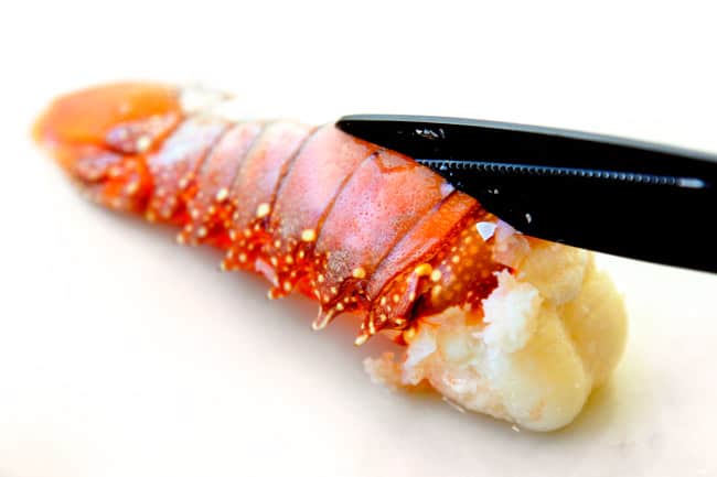 showing how to make lobster bisque by cuttitng lobster tails with kitchen shears