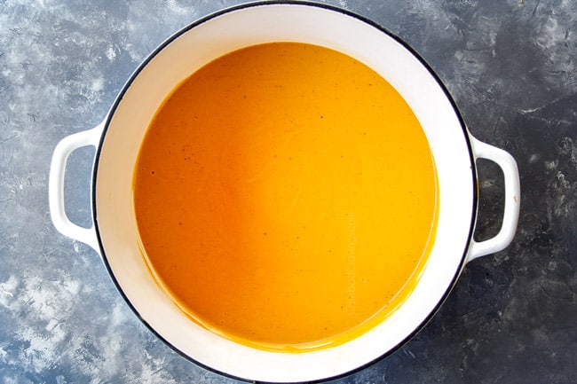 showing how to make lobster bisque by thickening soup in stockpot with half and half and cornstarch