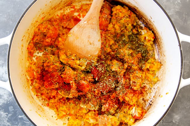 showing how to make lobster bisque by adding tomato paste and seasonings