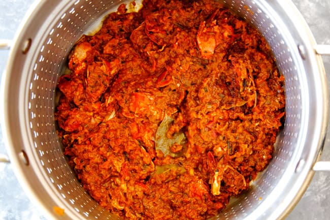 showing how to make lobster bisque by straining stock through colander to remove shells