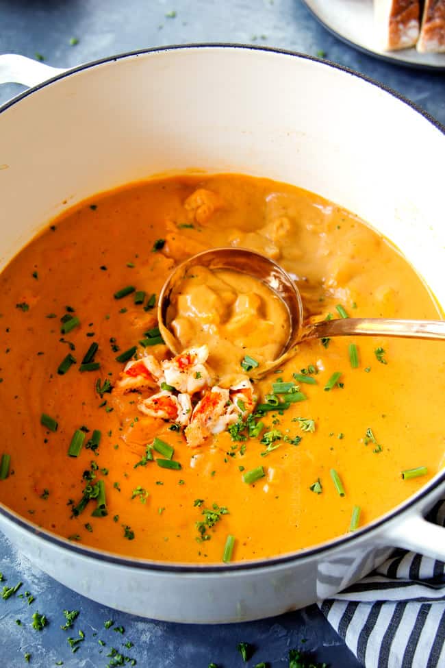 showing how to serve easy lobster bisque recipe with a ladle scooping up the soup