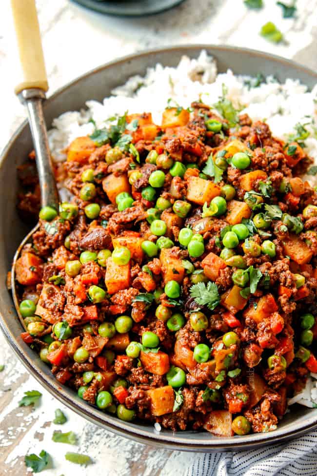 showing how to serve Picadillo Beef adding to a bowl with white rice
