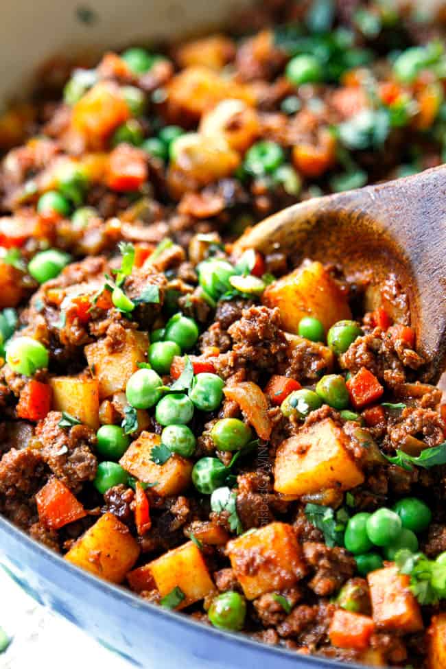 up close showing how to make Picadillo recipe by reducing liquid until it is saucy