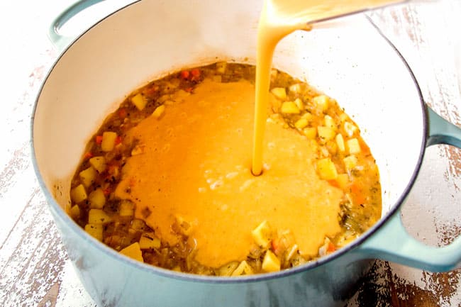 showing how to make potato leek soup by adding pureed soup back to pot